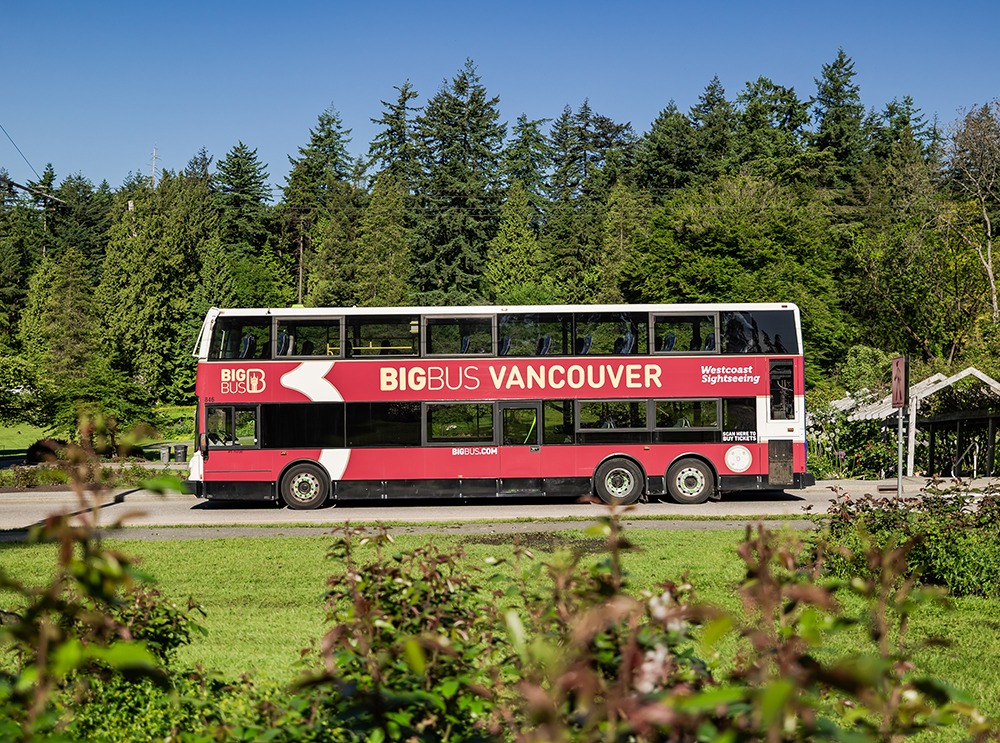 A Big Bus Tour bus driving through the scenic Vancouver, BC 